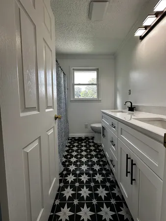 a kitchen with sink and cabinets