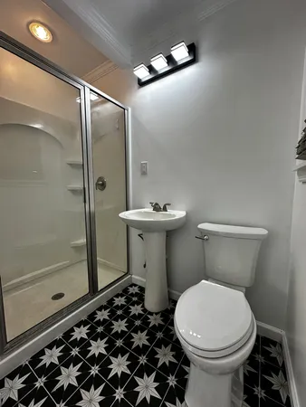 a bathroom with a sink toilet and shower