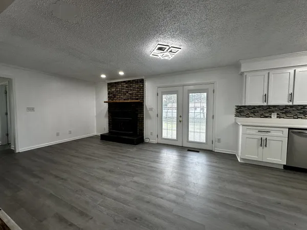 a view of kitchen with wooden floor and electronic appliances