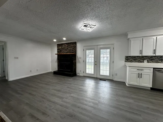 a view of kitchen with wooden floor and electronic appliances