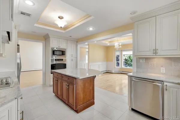 a kitchen with stainless steel appliances granite countertop a refrigerator and a stove