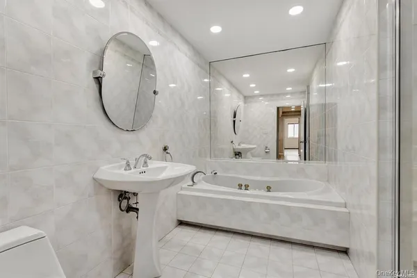 a bathroom with a sink a mirror and a bathtub