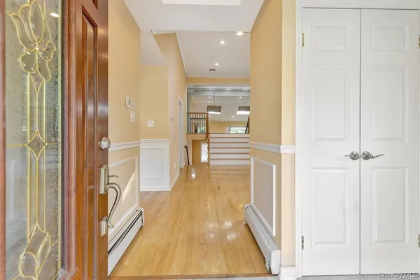 a view of a hallway with wooden floor and staircase