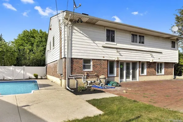 a view of a house with backyard and sitting area