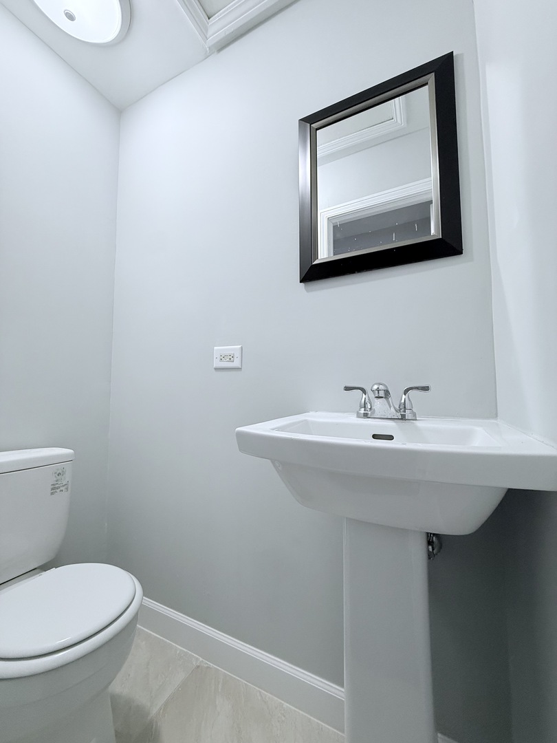 2658 West 83rd Street Chicago, IL 60652 - Photo 15 of 37 a bathroom with a toilet a sink and mirror