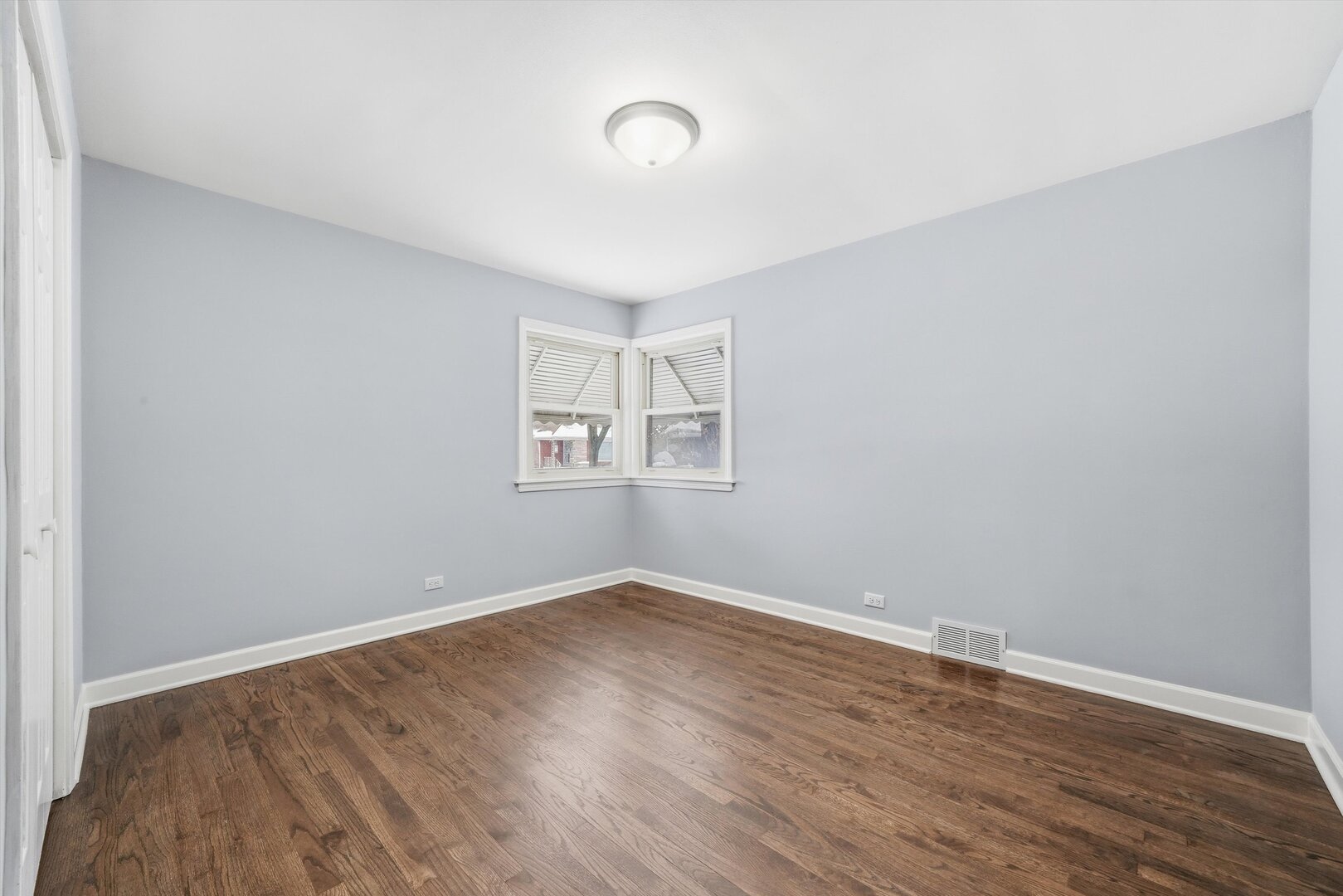 2658 West 83rd Street Chicago, IL 60652 - Photo 21 of 37 an empty room with wooden floor and windows