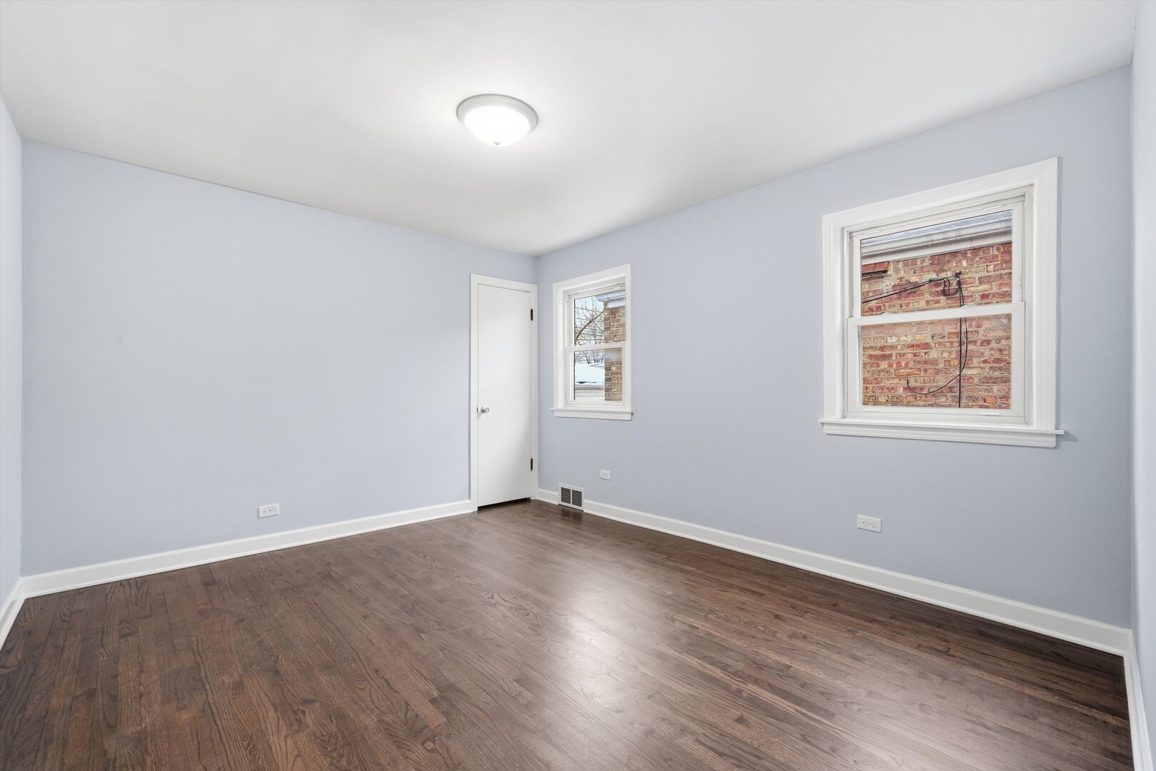 2658 West 83rd Street Chicago, IL 60652 - Photo 22 of 37 a view of an empty room with wooden floor and a window