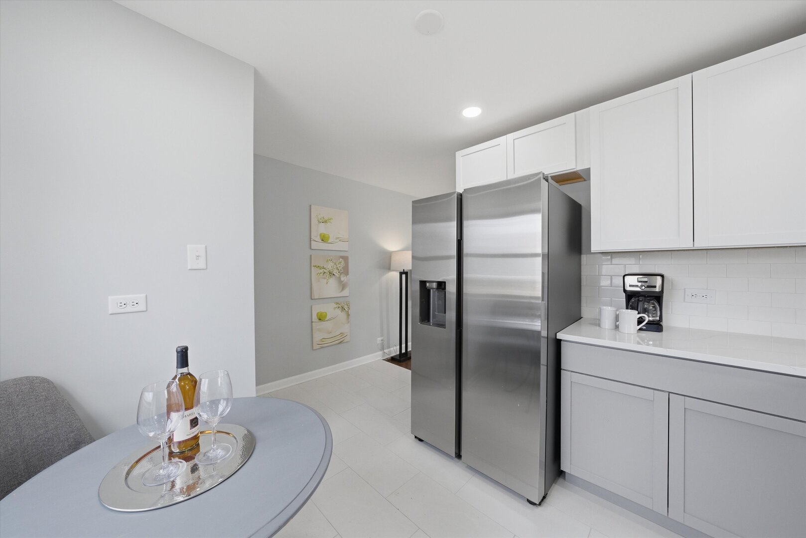 2658 West 83rd Street Chicago, IL 60652 - Photo 8 of 37 a kitchen with stainless steel appliances a refrigerator a sink a stove a dining table and chairs