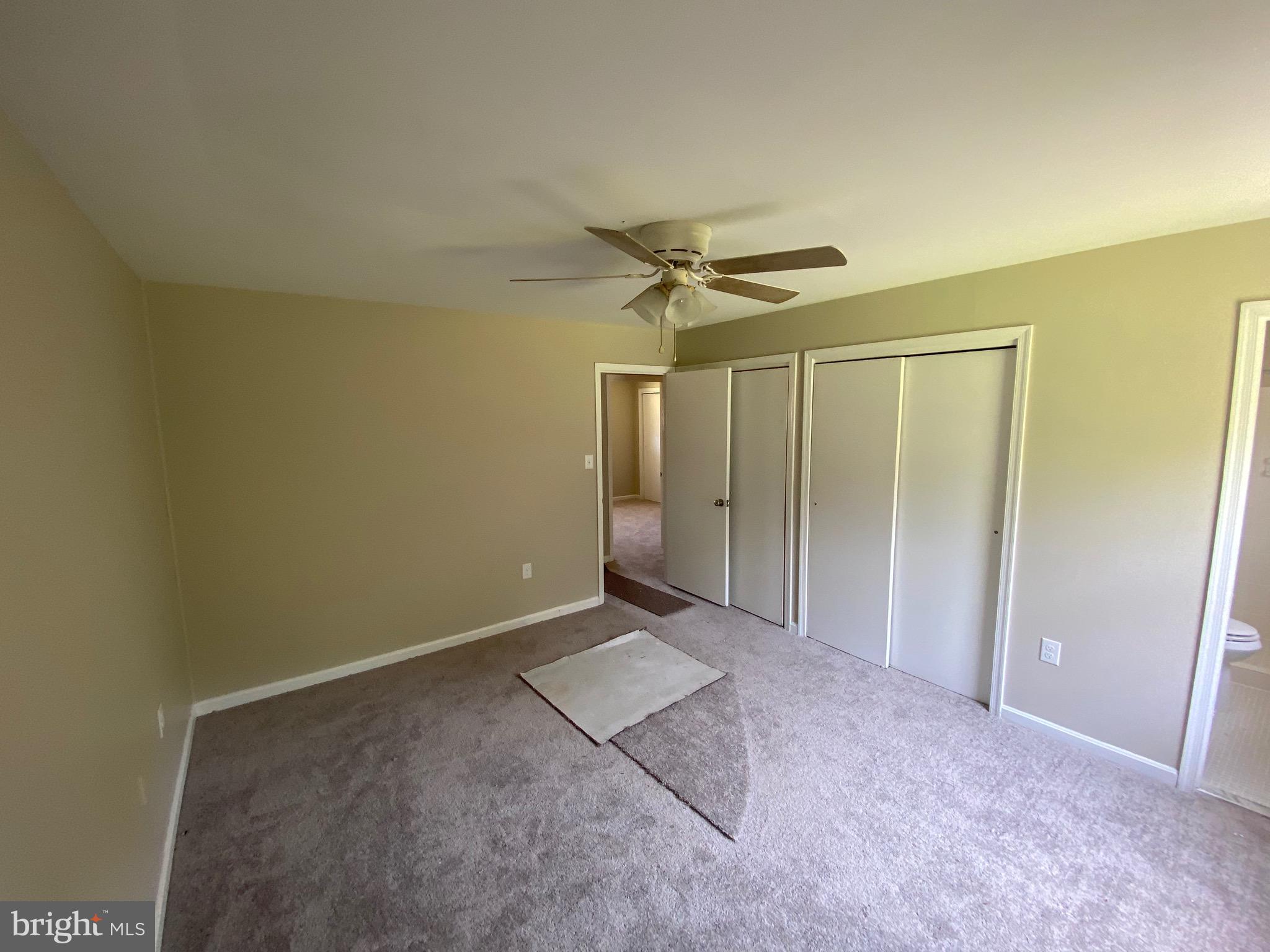 11711 Butlers Branch Road Clinton, MD 20735 - Photo 13 of 23 an empty room with a ceiling fan and a window