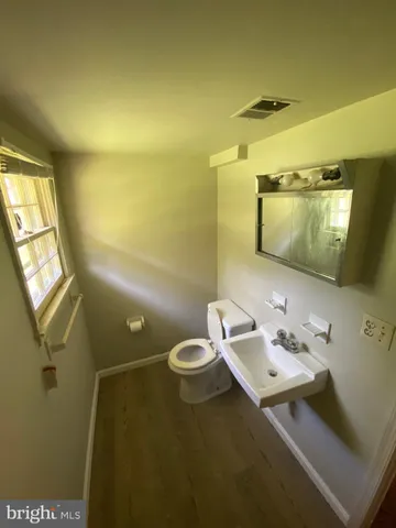 a white toilet sitting next to a bathroom sink