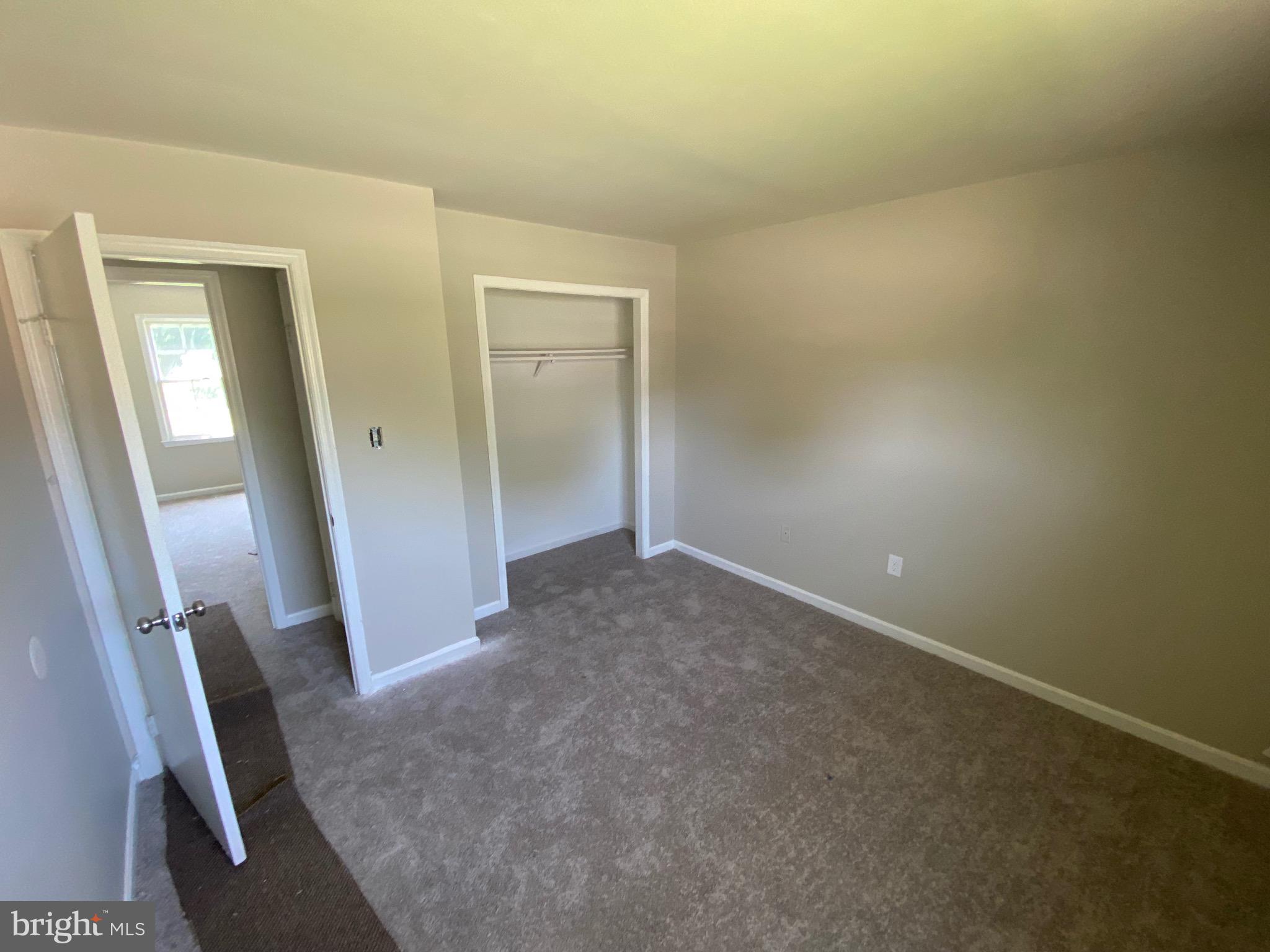 11711 Butlers Branch Road Clinton, MD 20735 - Photo 17 of 23 an empty room with wooden floor and stairs