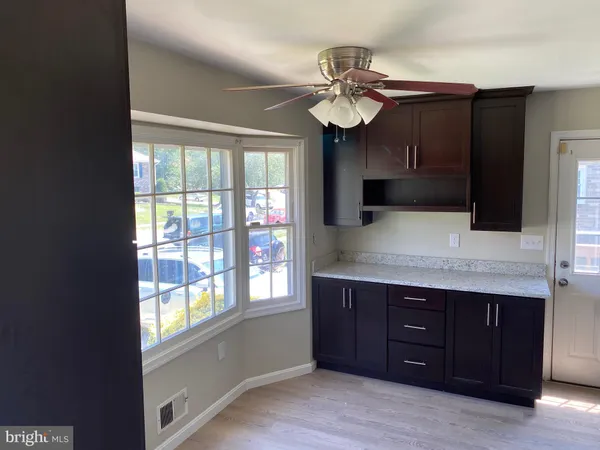 a view of a kitchen counter space and wooden floor