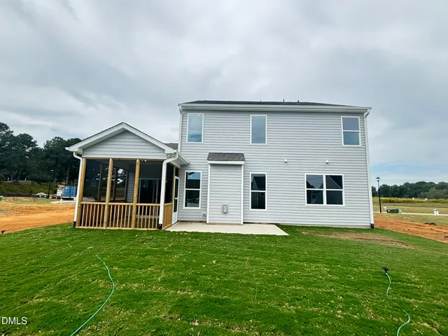 a view of a big yard with an outdoor seating