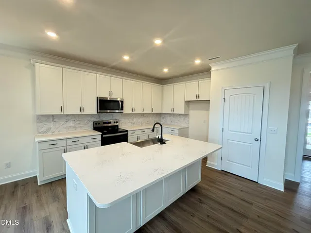 a kitchen with wooden cabinets and white appliances