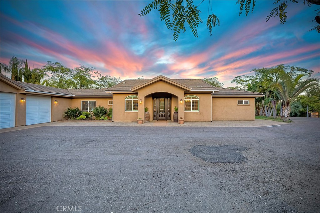a view of house with outdoor space and garden