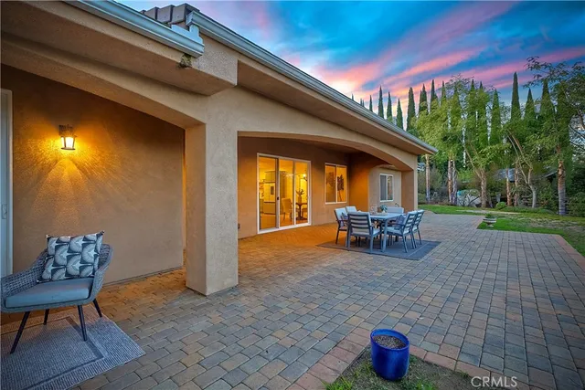 a view of a patio with table and chairs and potted plants