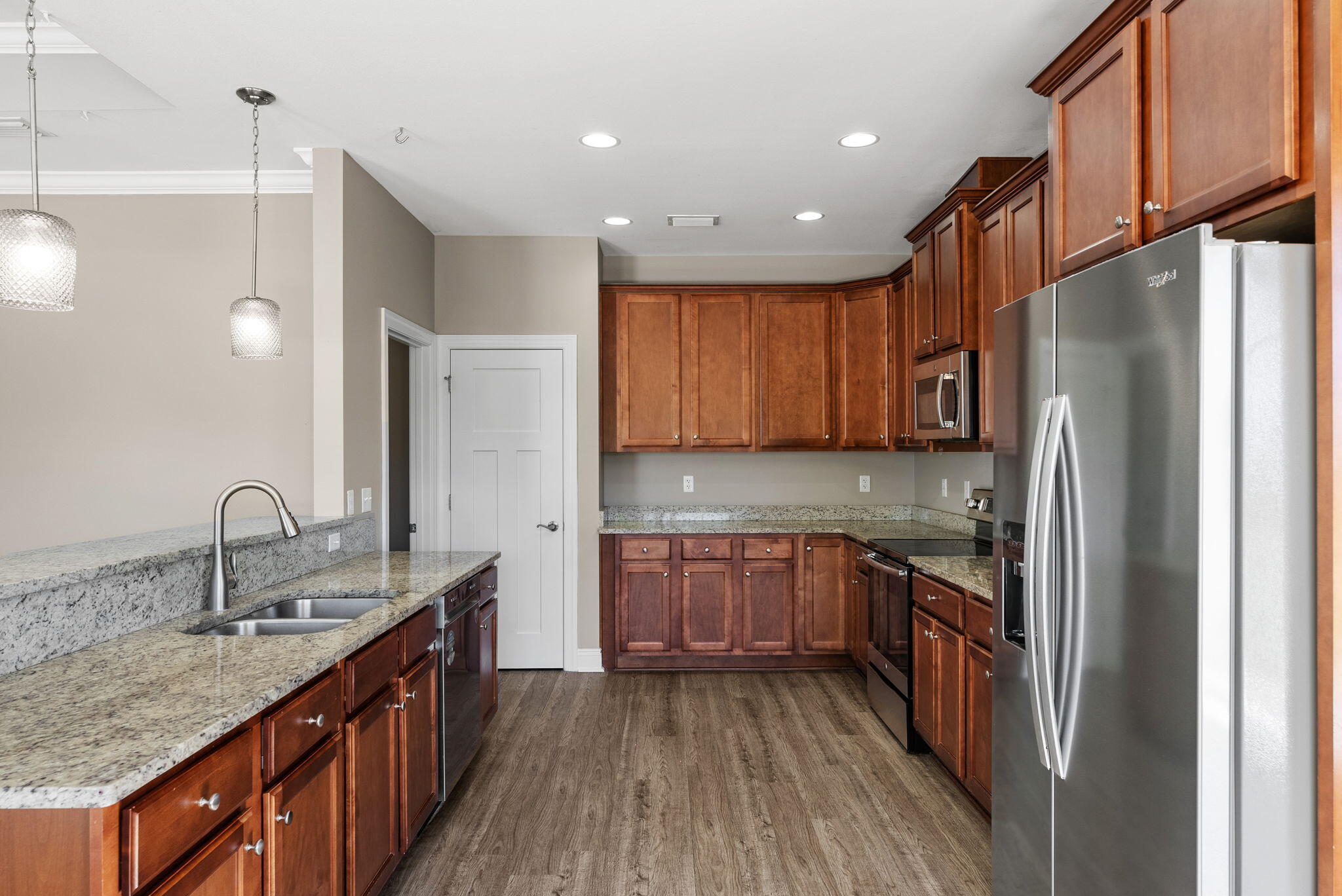 266 Partridge Lane Freeport, FL 32439 - Photo 11 of 36 a kitchen with stainless steel appliances granite countertop refrigerator a sink dishwasher a stove and white countertops with wooden floor