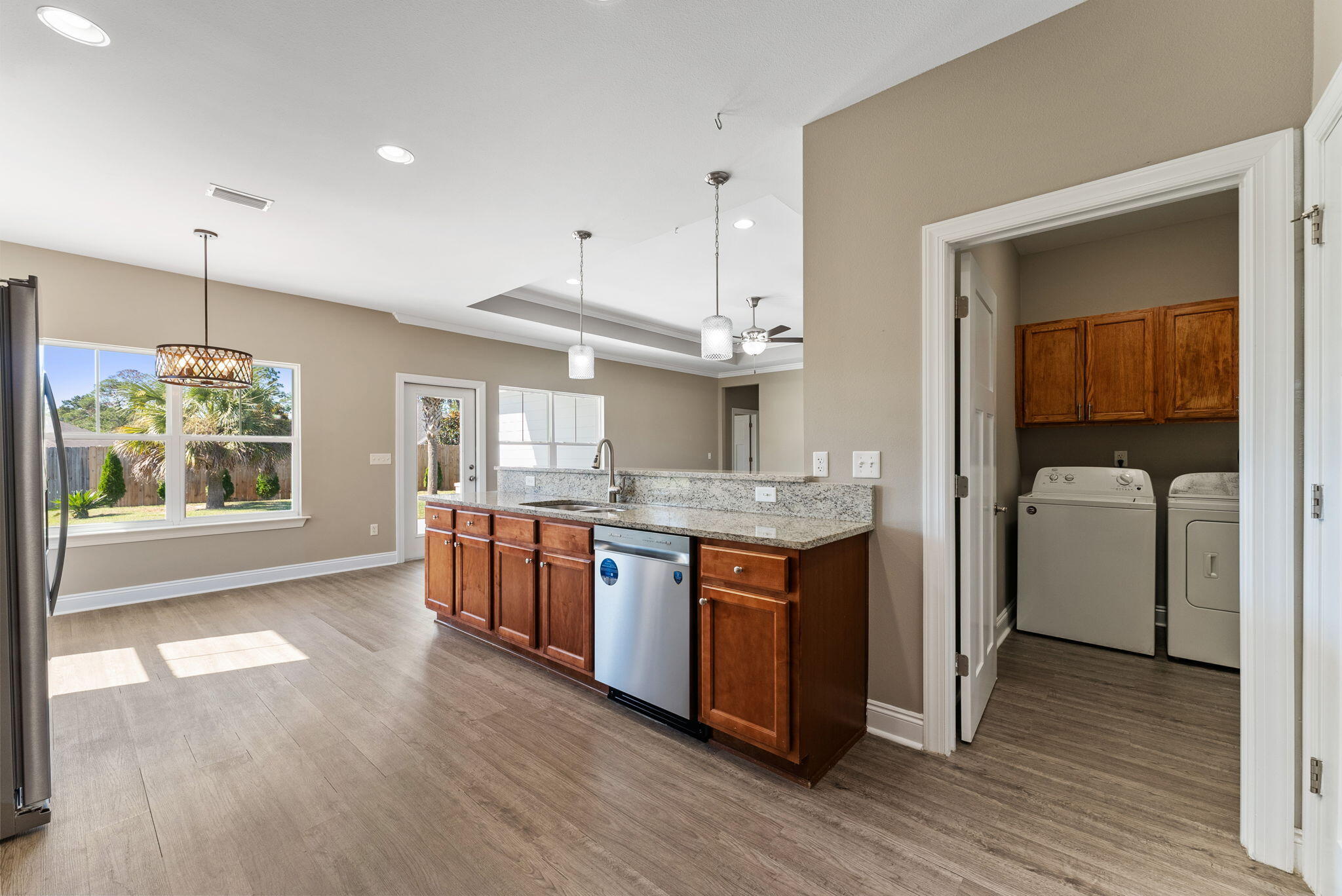 266 Partridge Lane Freeport, FL 32439 - Photo 13 of 36 a kitchen with kitchen island granite countertop a stove a sink a refrigerator wooden floor and cabinets
