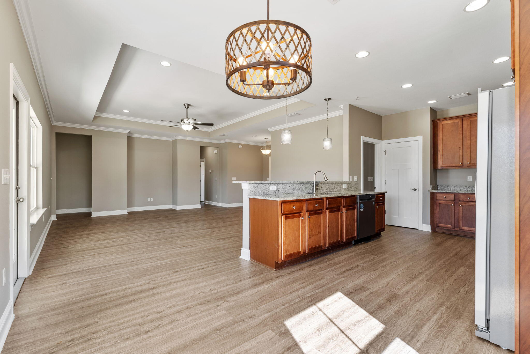 266 Partridge Lane Freeport, FL 32439 - Photo 14 of 36 an open kitchen with a refrigerator and wooden floor
