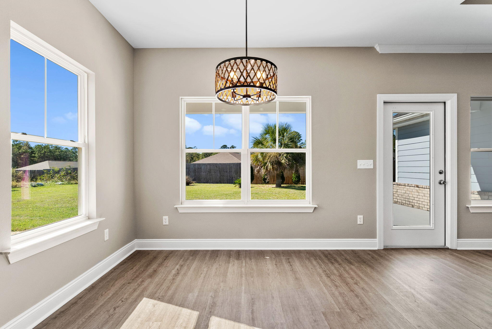 266 Partridge Lane Freeport, FL 32439 - Photo 15 of 36 a view of an empty room with wooden floor and a window
