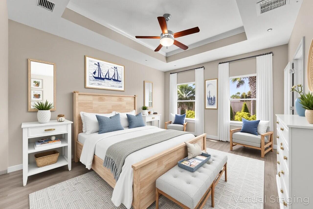 266 Partridge Lane Freeport, FL 32439 - Photo 18 of 36 a bedroom with a large bed and a chandelier