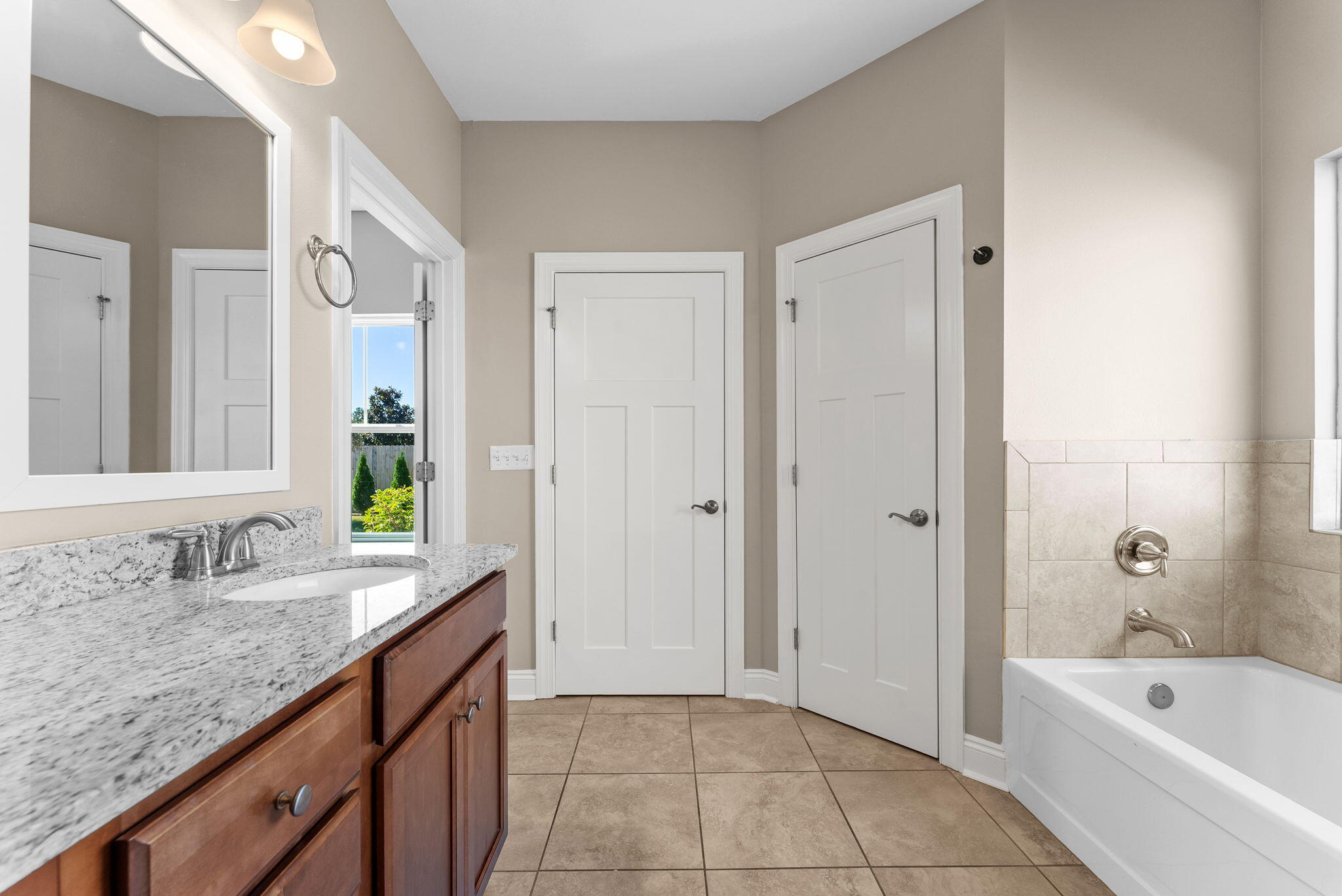 266 Partridge Lane Freeport, FL 32439 - Photo 23 of 36 a spacious bathroom with a granite countertop tub sink and mirror