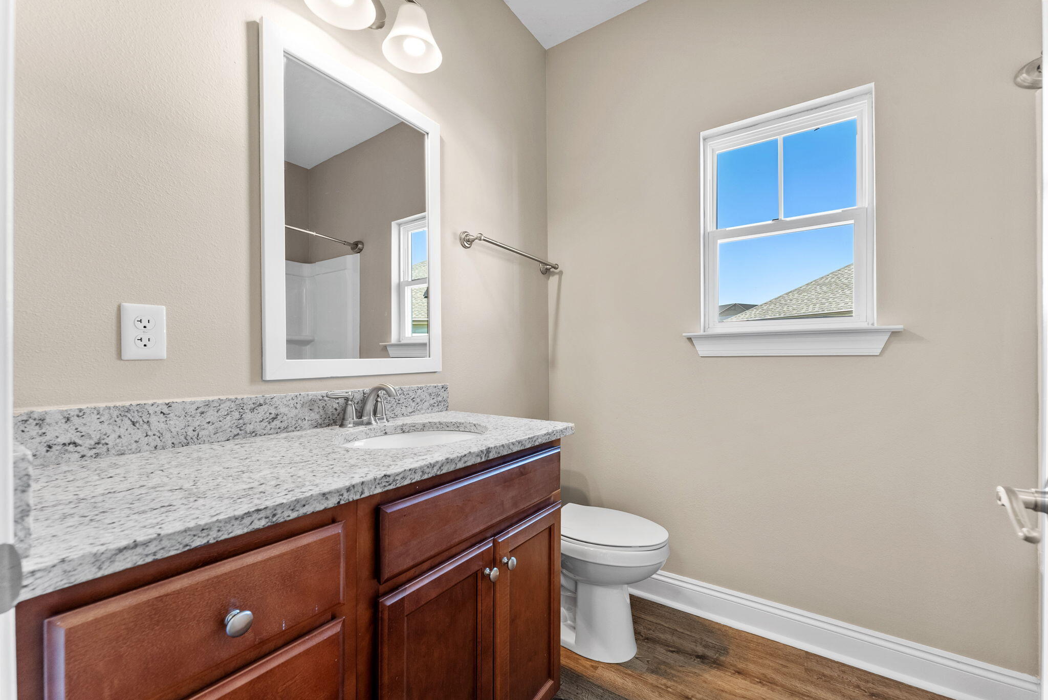 266 Partridge Lane Freeport, FL 32439 - Photo 30 of 36 a bathroom with a granite countertop toilet sink and mirror