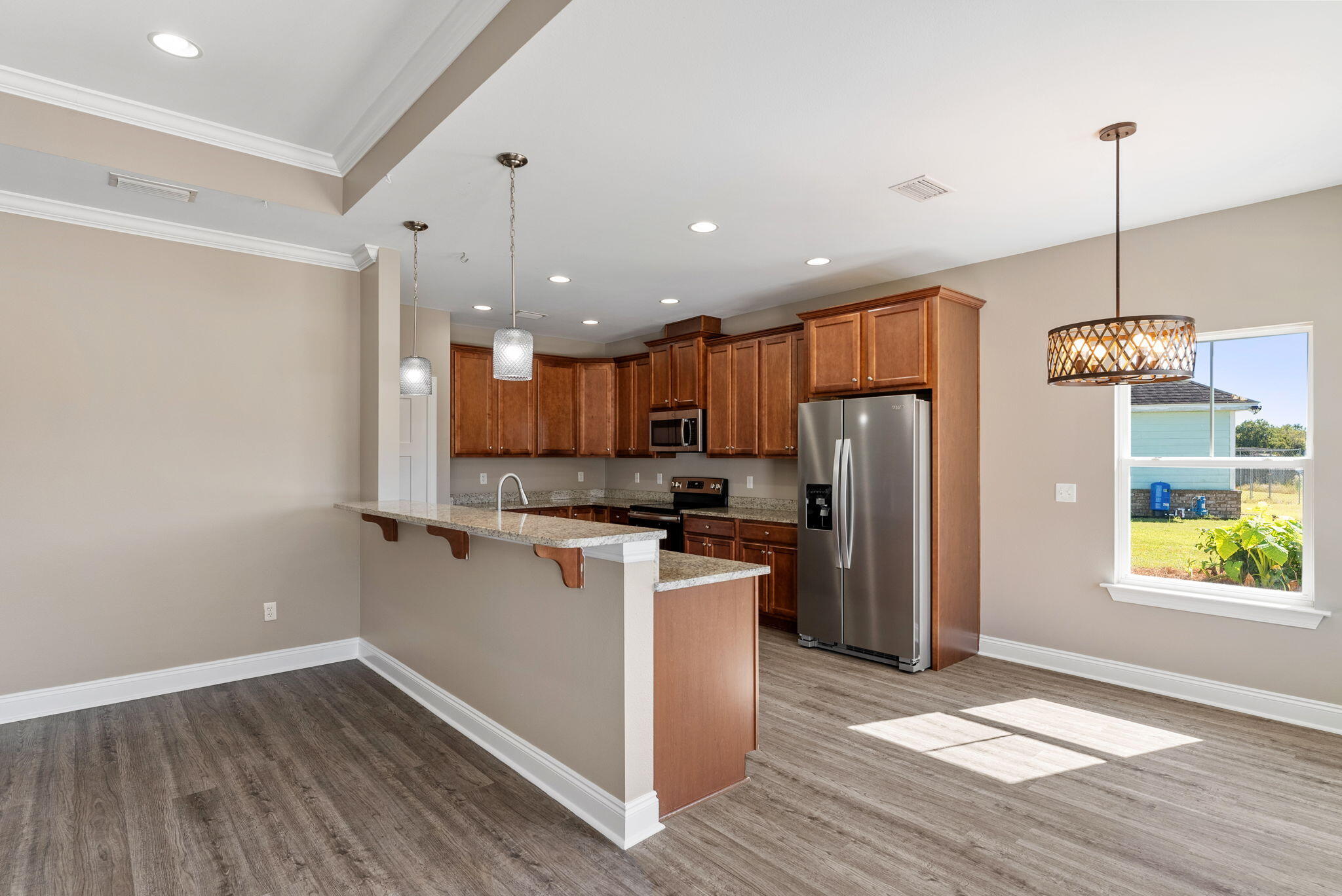 266 Partridge Lane Freeport, FL 32439 - Photo 10 of 36 a kitchen with stainless steel appliances granite countertop a refrigerator a sink dishwasher a stove and white countertops with wooden floor