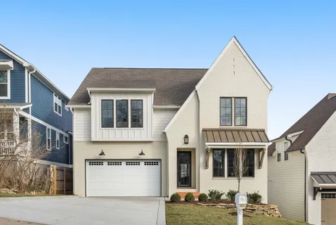 a view of a white house with large windows