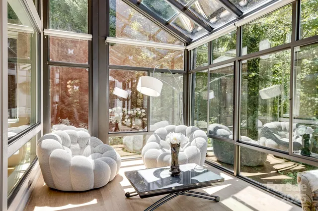 a living room with furniture and a floor to ceiling window