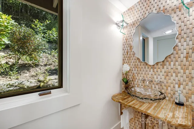 a view of entryway with paintings on the wall