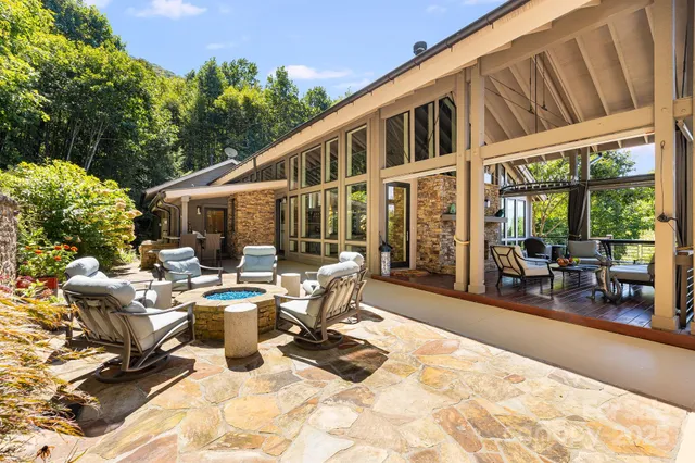a view of a patio with table and chairs and potted plants