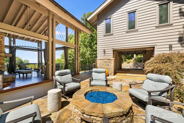 a view of a patio with couches chairs and a fire pit