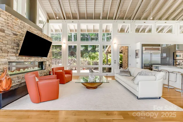 a living room with fireplace furniture and a flat screen tv