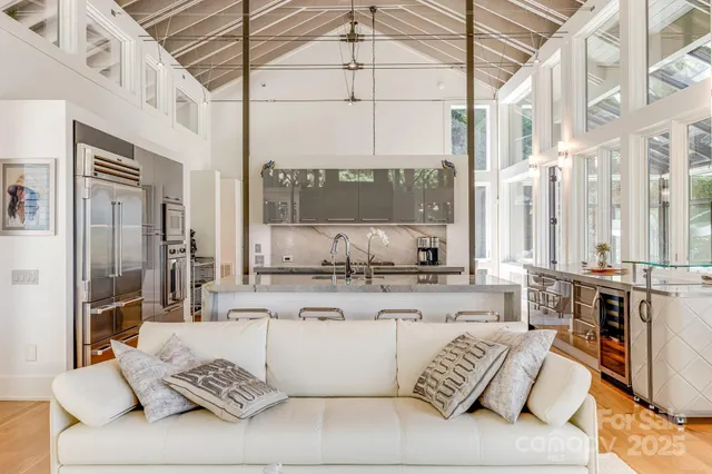 a large white kitchen with a large window