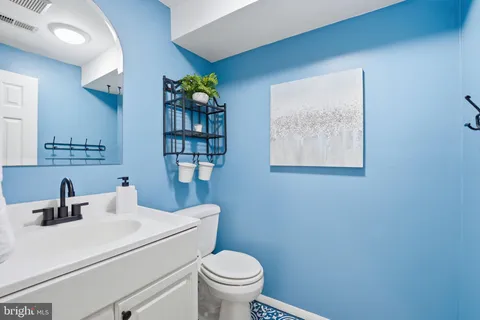 a bathroom with a toilet sink and mirror