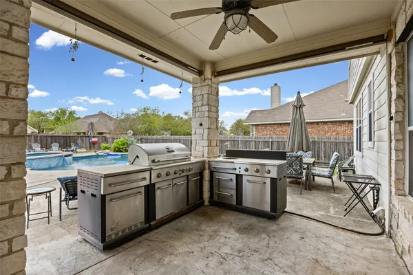 a open kitchen with stainless steel appliances granite countertop a stove and refrigerator