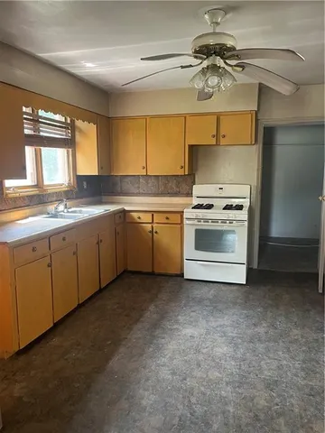 a kitchen with a sink cabinets and window