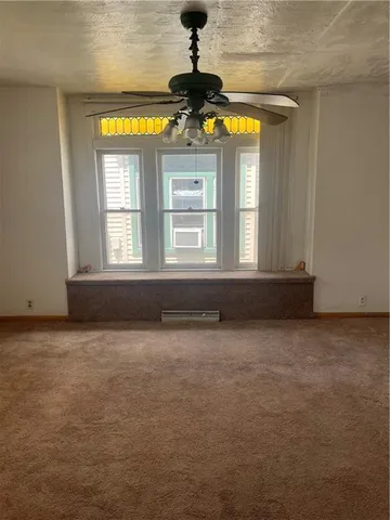a view of empty room with a fireplace