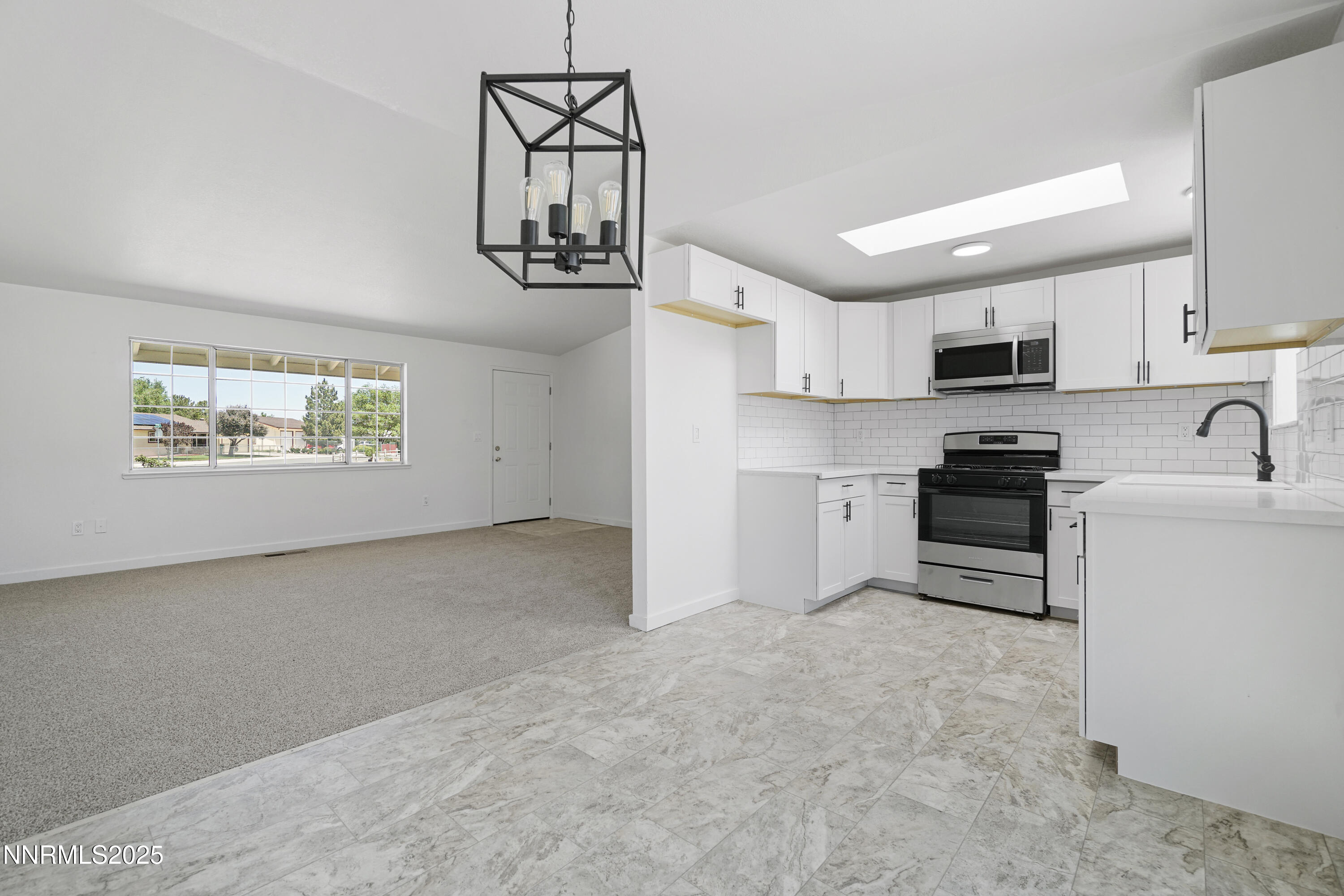 266 River Boat Road Dayton, NV 89403 - Photo 7 of 25 a kitchen with stainless steel appliances granite countertop a stove sink and microwave