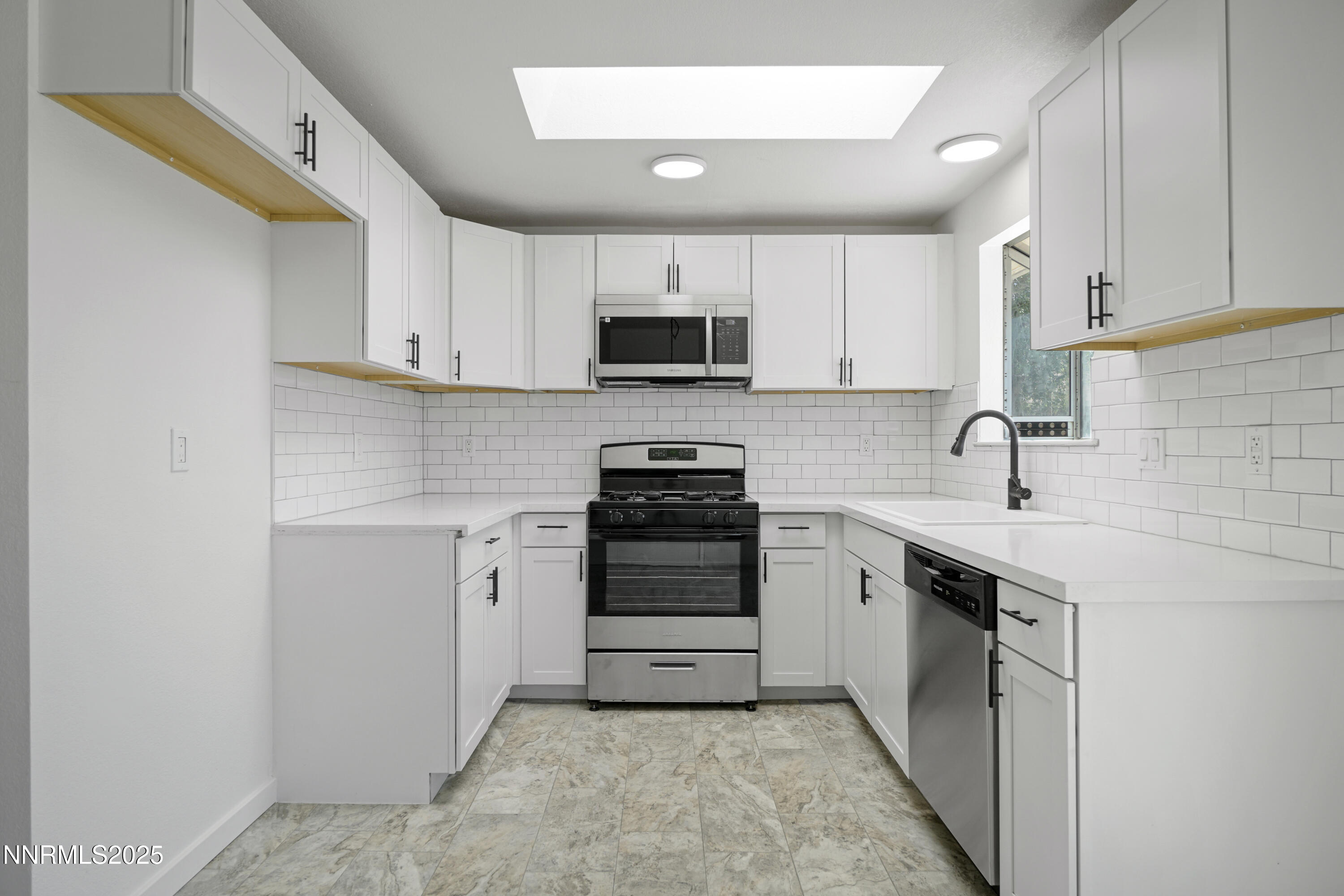 266 River Boat Road Dayton, NV 89403 - Photo 8 of 25 a kitchen with a sink stove and microwave