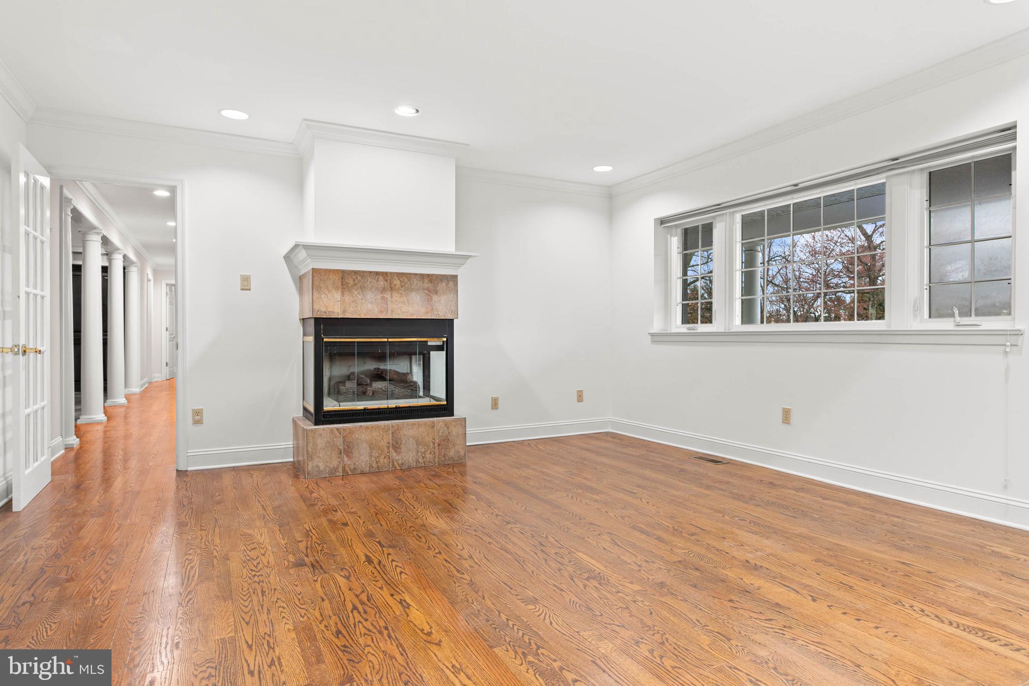 753 Mustin Lane Villanova, PA 19085 - Photo 16 of 40 a view of an empty room with a fireplace and a window