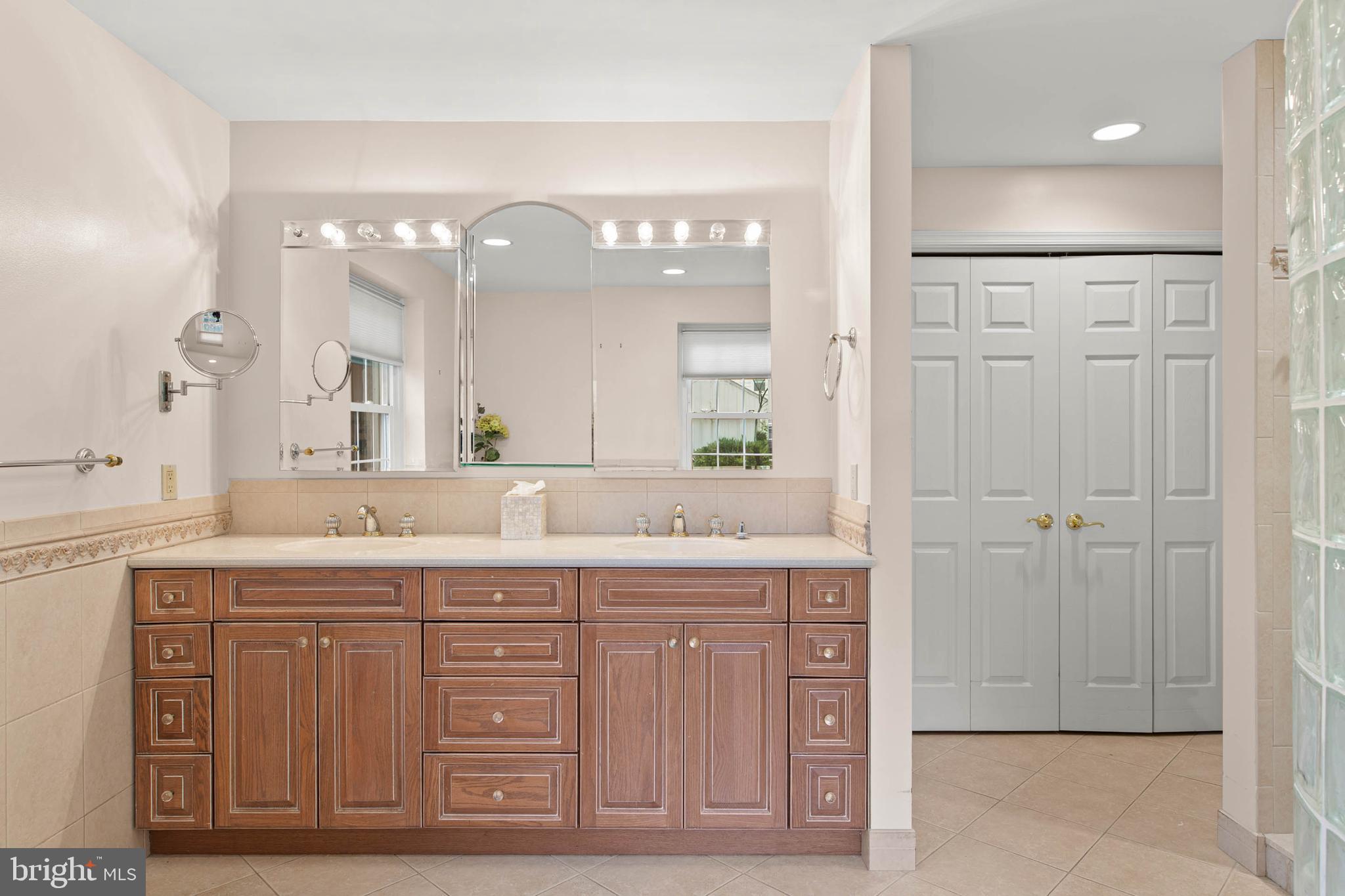 753 Mustin Lane Villanova, PA 19085 - Photo 21 of 40 a spacious bathroom with a granite countertop sink a mirror and a