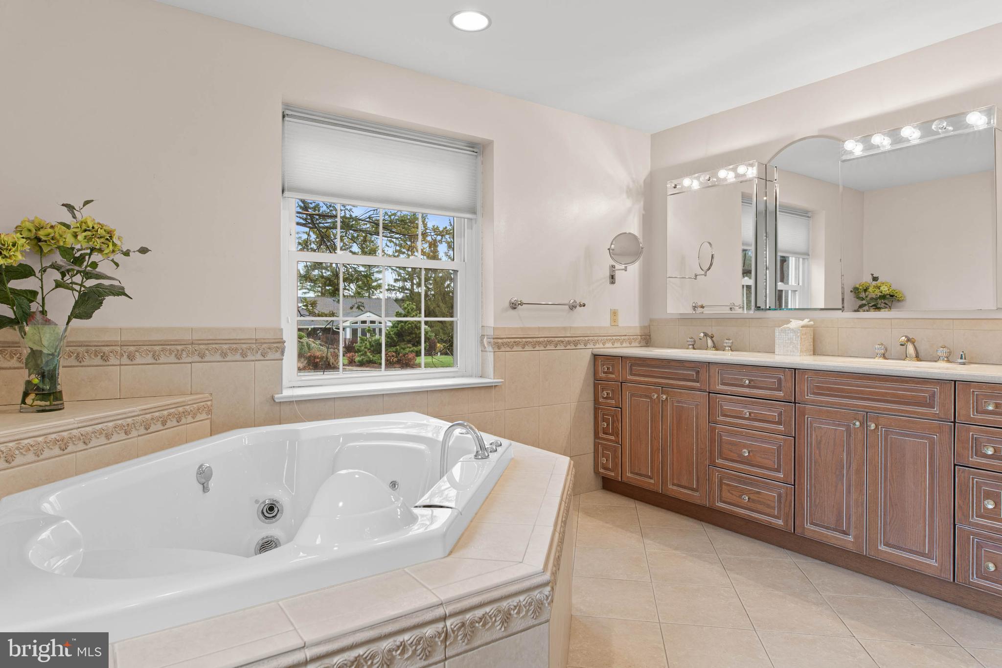 753 Mustin Lane Villanova, PA 19085 - Photo 22 of 40 a spacious bathroom with a tub sink and mirror