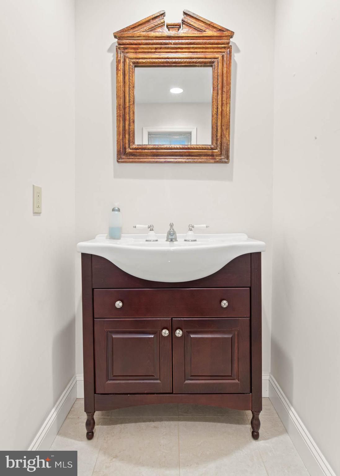 753 Mustin Lane Villanova, PA 19085 - Photo 26 of 40 a bathroom with a sink and a mirror