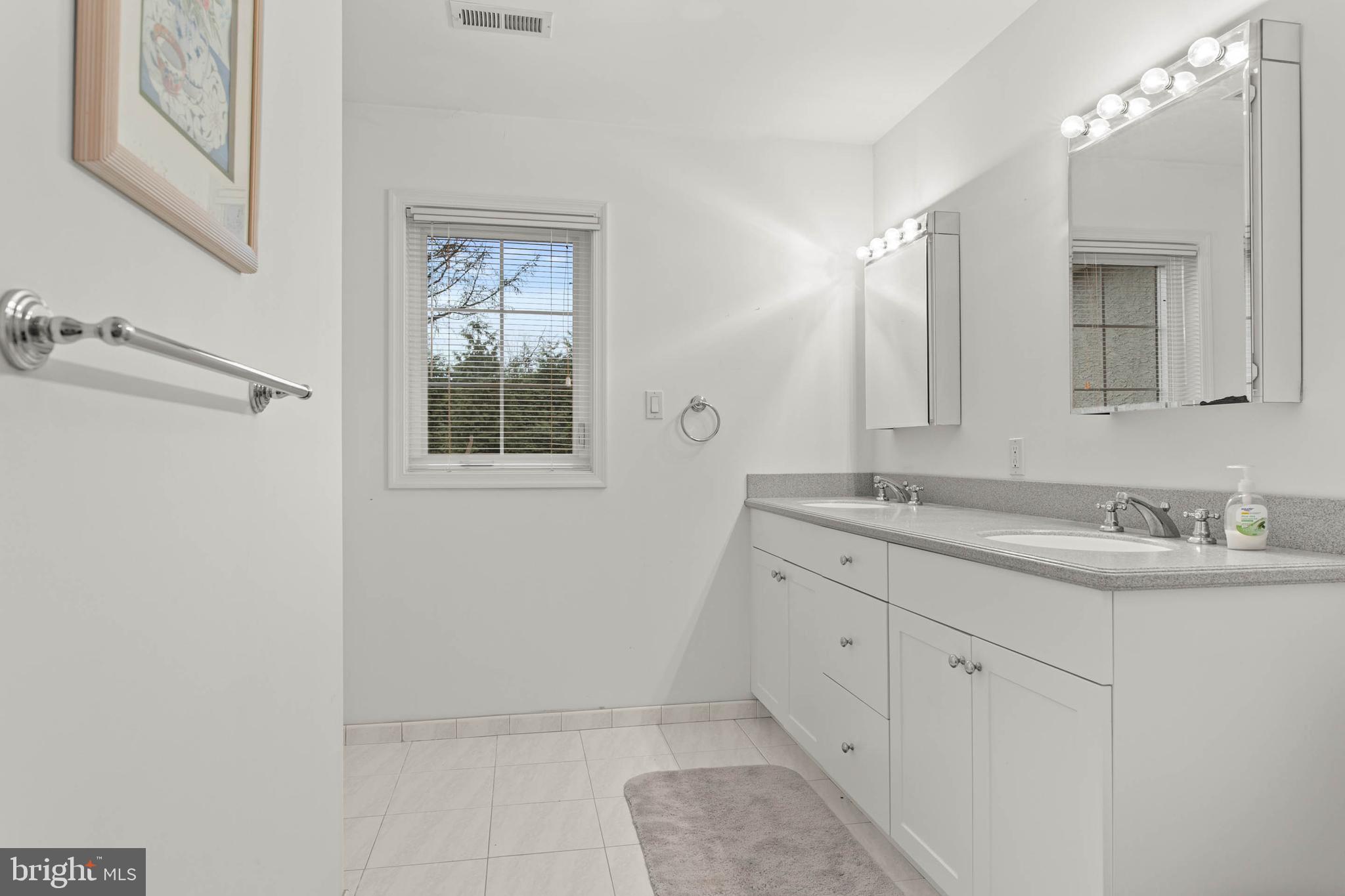 753 Mustin Lane Villanova, PA 19085 - Photo 32 of 40 a bathroom with a double vanity sink and a mirror