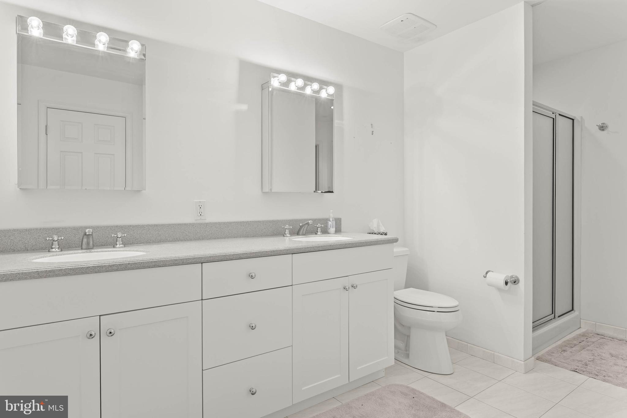 753 Mustin Lane Villanova, PA 19085 - Photo 33 of 40 a bathroom with 2 sink and a mirror