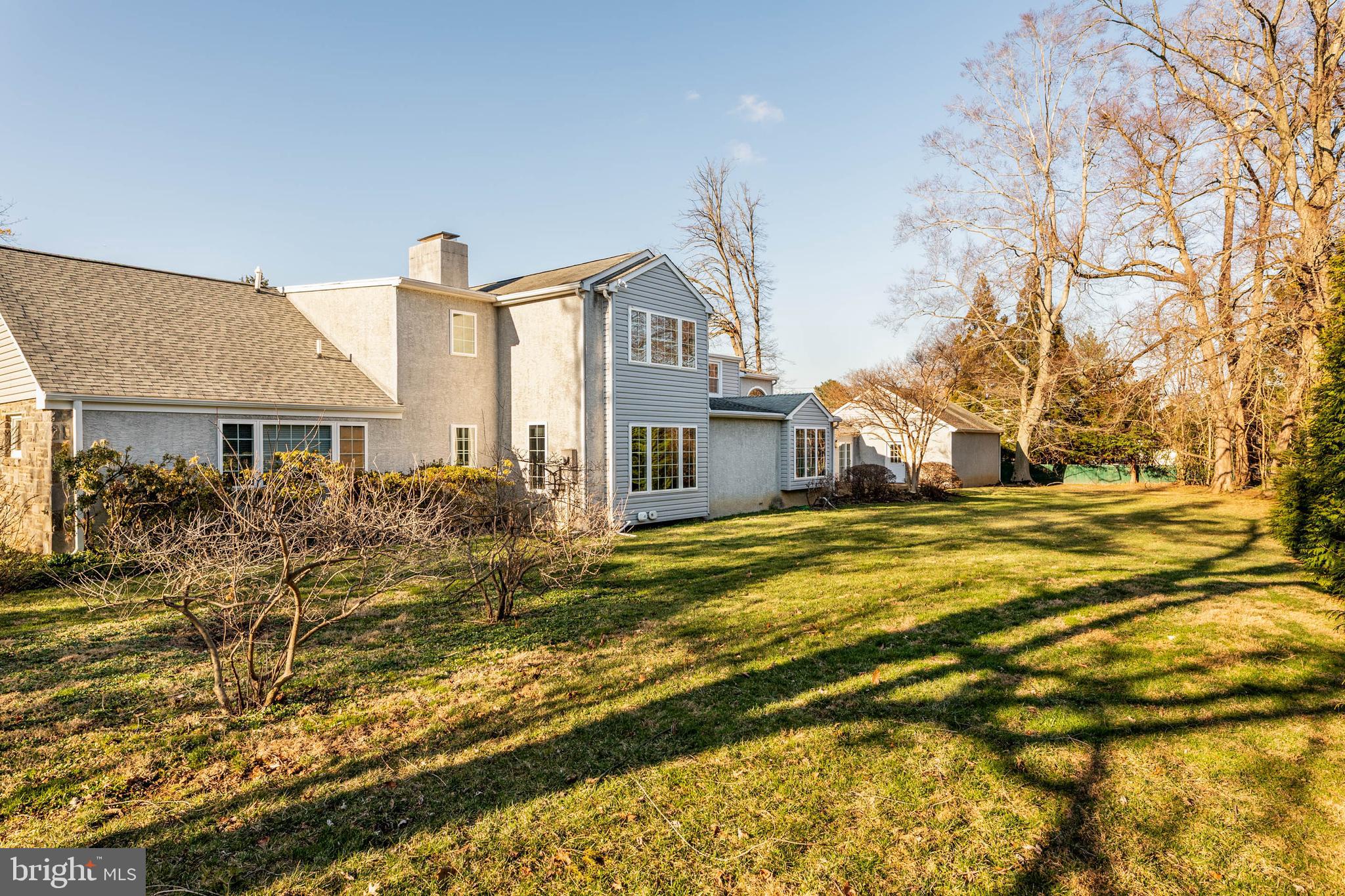 753 Mustin Lane Villanova, PA 19085 - Photo 40 of 40 a view of a house with a yard and lawn chairs under an umbrella