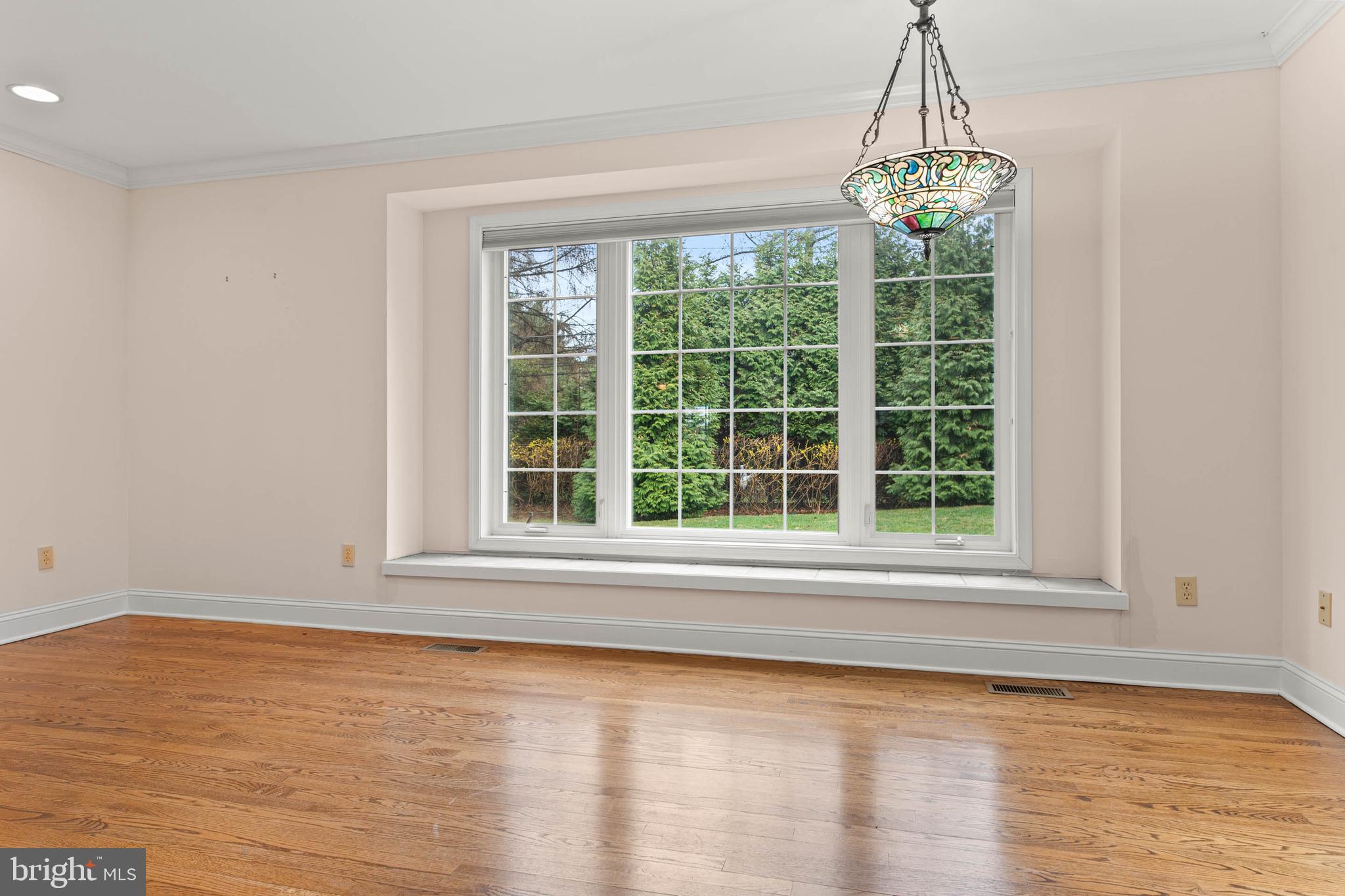 753 Mustin Lane Villanova, PA 19085 - Photo 6 of 40 a view of an empty room with wooden floor and a window
