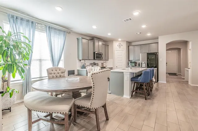 a dining room with furniture a window and appliances